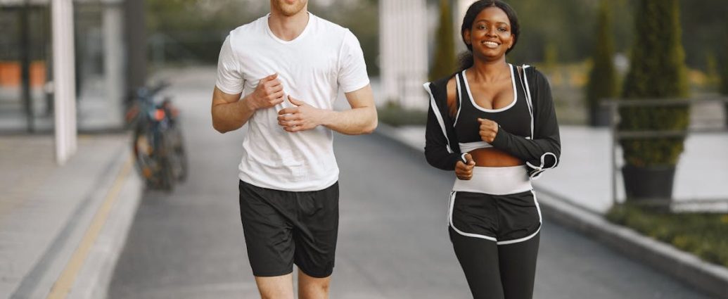 A man and woman jogging together outside, embracing a healthy lifestyle.